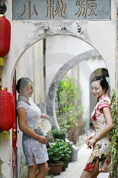 Chinese girlfriends in cheongsam enjoy free time