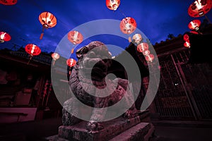 The Chinese Goddess of Mercy temple lion statue illuminated by lanterns, Georgetown, Malaysia
