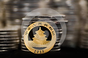 Chinese Gold Coin with Piles of Silver Coins