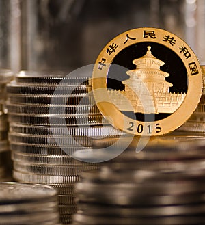Chinese Gold Coin among Stacks of Silver Coins