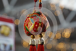 Chinese good luck charm hanging in front of a market stand in Greenwich London