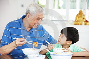 Chinese Grandfather And Grandson Eating Meal