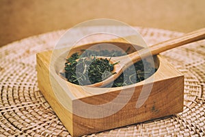 Chinese green tea in the wooden spoon