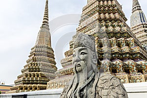 Chinese guardian figure in front of Phra Maha Chedi Si Ratchakan located in Wat Pho temple complex, Bangkok, Thailand