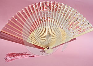 Chinese Hand Fan on Pink Background