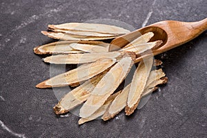 Chinese herbal medicines -- Astragalus on stone background, blank for text