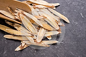 Chinese herbal medicines -- Astragalus on stone background, blank for text