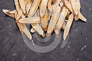 Chinese herbal medicines -- Astragalus on stone background, blank for text