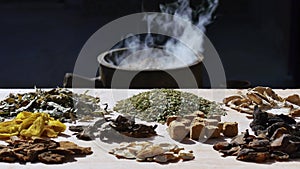 Chinese herbal medicines on table, herbs boiled in medicine jar