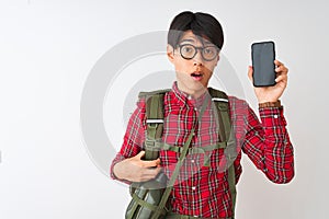 Chinese hiker man wearing canteen holding smartphone over isolated white background scared in shock with a surprise face, afraid