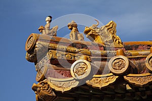 Chinese imperial roof decoration or roof charms, or roof figures with emperor and creatures in the Forbidden City in Beijing, Chin