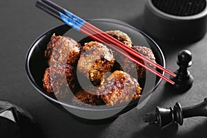 Chinese or Indian Veg Manchurian in a Black Bowl with Chopsticks - Asian Food