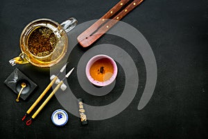 Chinese or japanese traditions. Calligraphy and tea ceremony concept. Special writting pen, ink near teapot and cup of