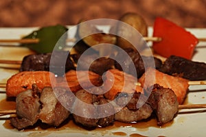 Chinese kebab on a white plate in Asian restaurant