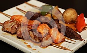 Chinese kebab on a white plate in Asian restaurant