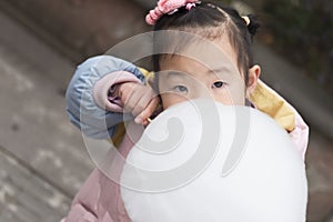 Chinese kid eating marshmallow