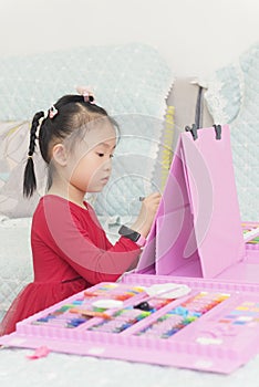 Chinese kid painting on toy artboard