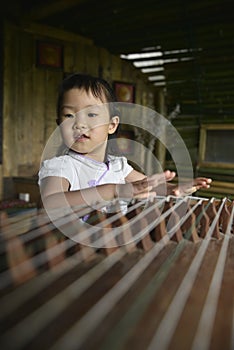 Chinese kid try to playing with traditional Musical instrument