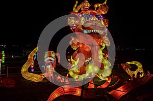 Chinese Lantern Festival in honor of the New Year. Sculpture depicting a red dragon with street lighting