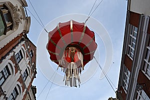Chinese lantern hanging between buildings London Chinatown