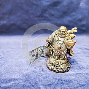 Chinese laughing god and american 100 dollars. Symbol of wealth and prosperity. Chinese New Year 2020 concept.