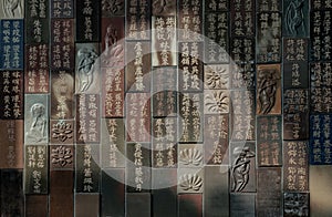 Chinese lettering teachings and Carved buddha images into a slab of colored tiles on temple wall