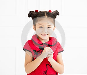 Chinese little girl with congratulation gesture