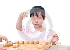 Chinese little girl is playing Chinese chess seriously