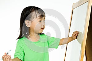 Chinese little girl writing on whiteboard