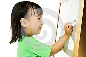 Chinese little girl writing on whiteboard