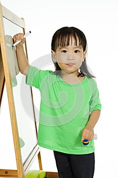 Chinese little girl writing on whiteboard