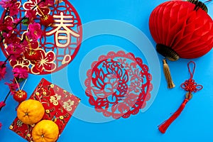 Chinese lunar new year decoration over blue background.