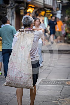 Chinese man carrying heavy load