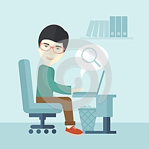 Chinese man sitting infront his computer