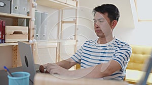 Chinese man working in a home office