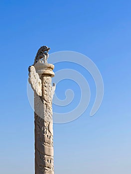 Chinese marble carved columns Huabiao against a clear blue sky. photo