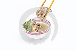Chinese meat soup with chopstick