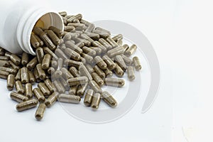 Chinese medicine capsules out of a bottle