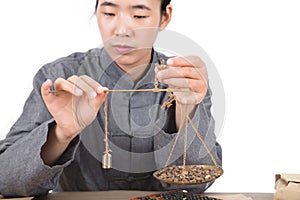 Chinese medicine practitioners are using small scales to weigh herbal medicine