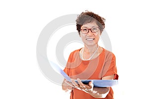 Chinese middle-aged woman worker opens a folder to view in front of white background