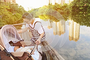 Chinese mom taking care of newborn baby in baby carriage