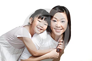 Chinese mother and daughter smiling and playing