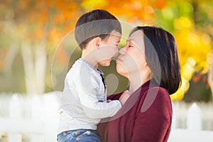 Chinese Mother Smooching Her Mixed Race Toddler Son photo