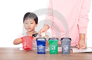 Chinese mothers teach their children how to classify trash in their lives