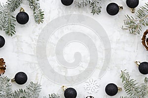 Chinese New Year composition. with Christmas black balls and fir tree decorations on white grunge background. Flat lay