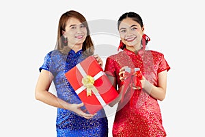 Chinese new year concept. Two Asian women in Cheongsam dres holding gift boxes on white background