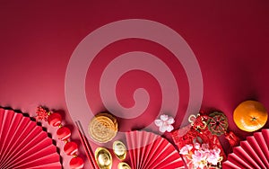 Chinese new year decorations made from red packet, orange and gold ingots or golden lump.
