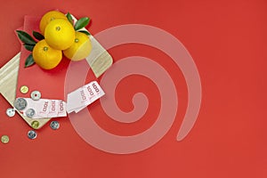 Chinese new year fresh oranges and angpao pocket with wooden board on red paper background