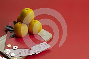 Chinese new year fresh oranges and angpao pocket with wooden board on red paper background