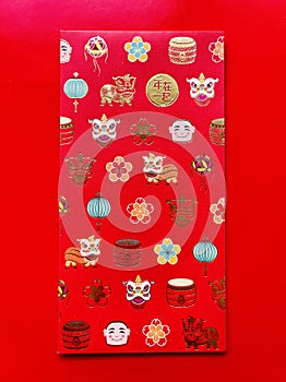 Chinese New Year multi golden colorful design on red envelope on red background.